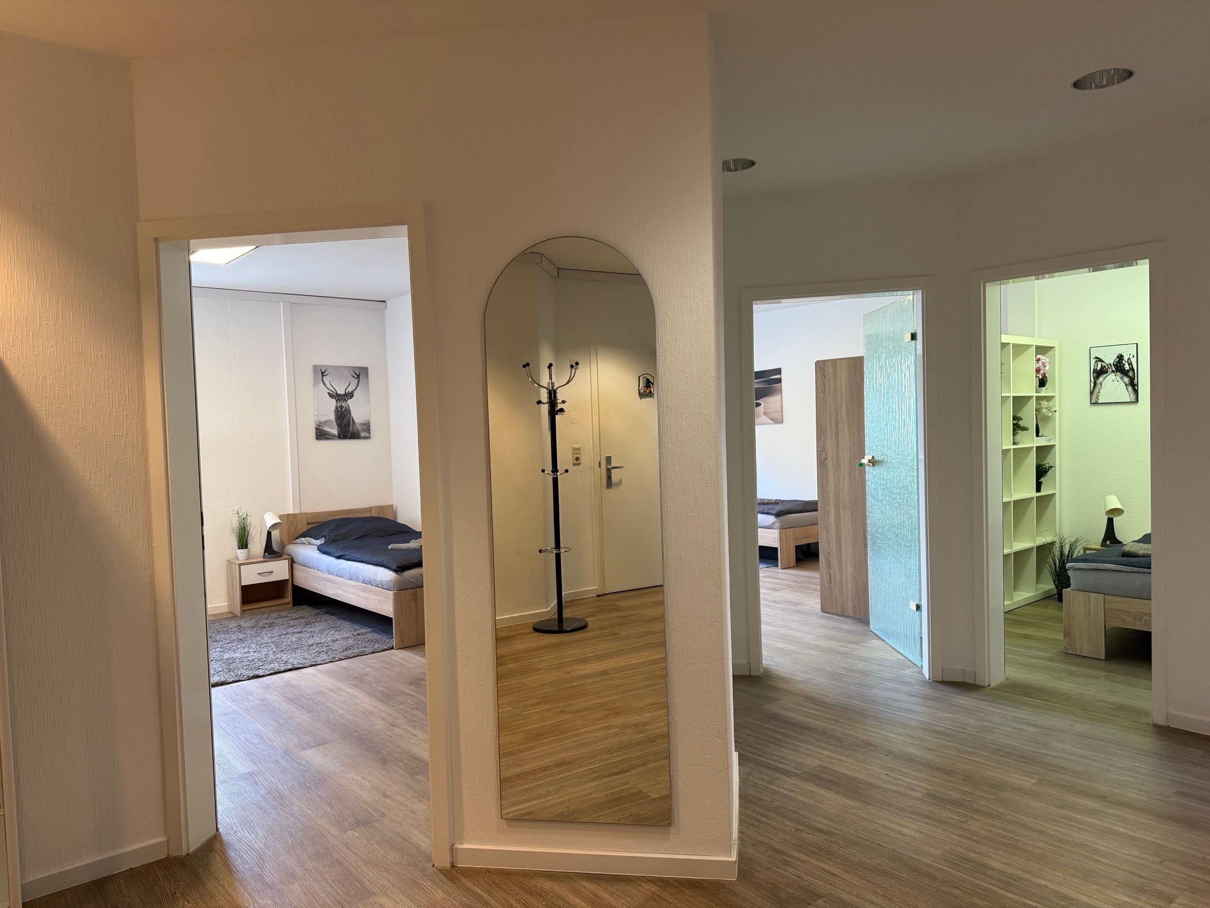 Bright hallway with a view into several rooms of a furnished MA-Flats apartment